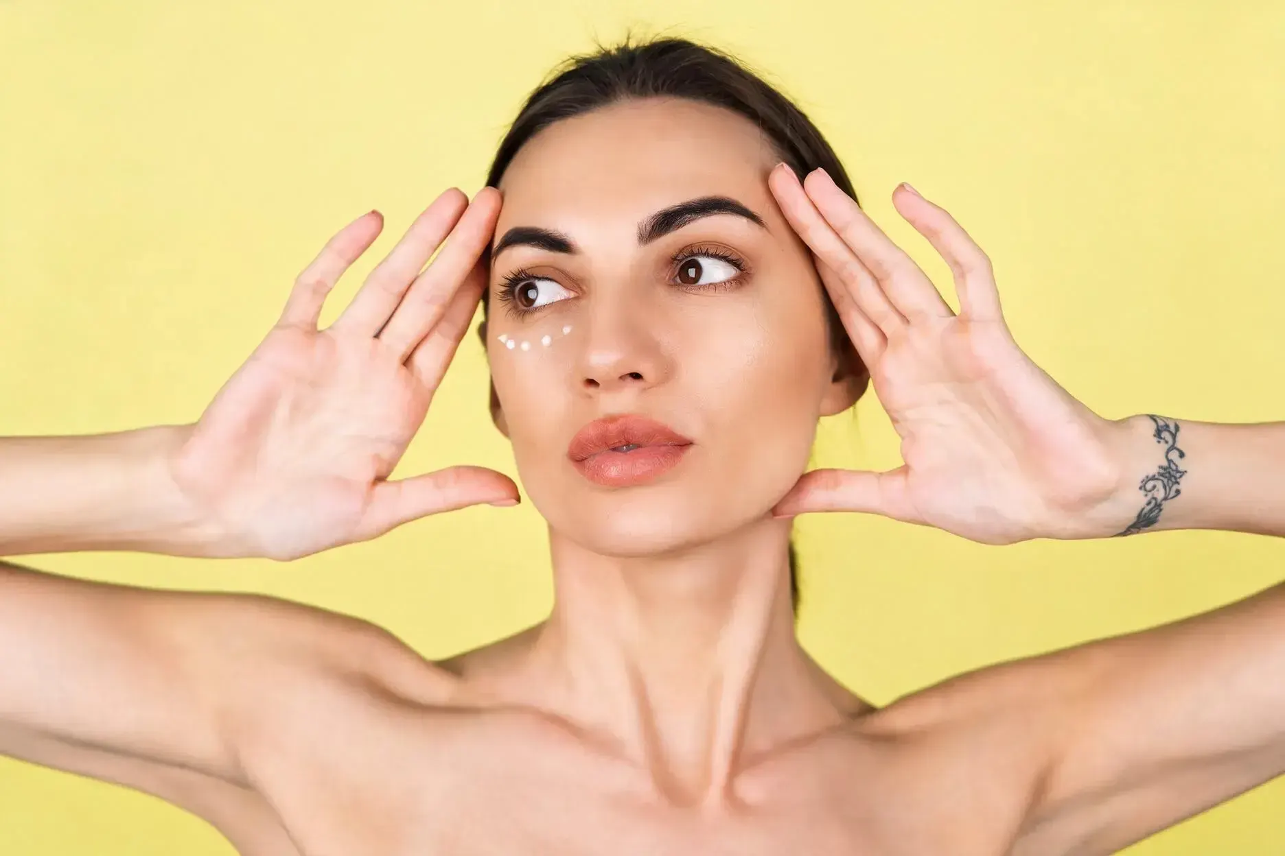 Woman noticing under eye shadows and considering under eye filler at Healthy Enhancements