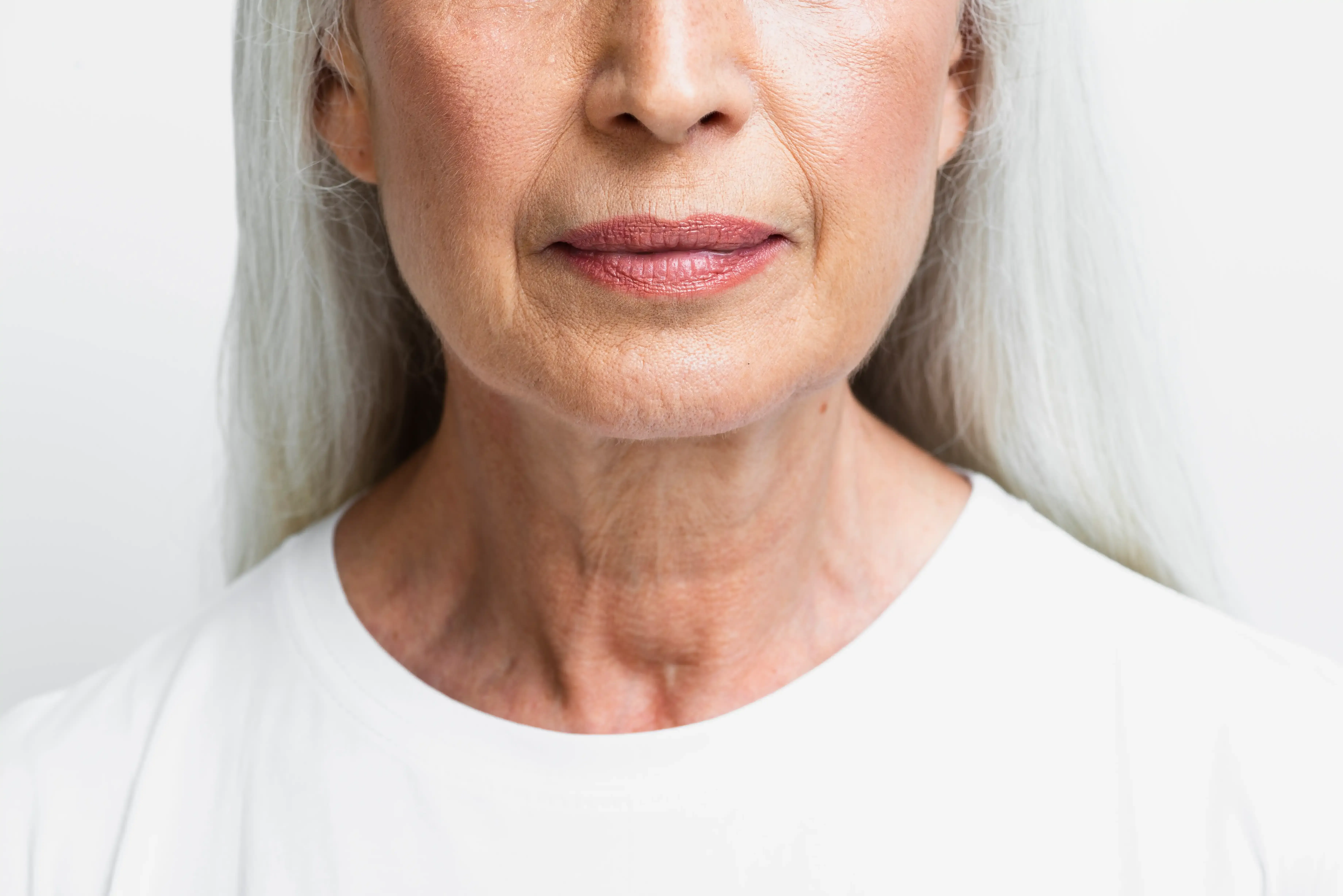 Woman noticing vertical lip lines above her mouth at Healthy Enhancements Wellington